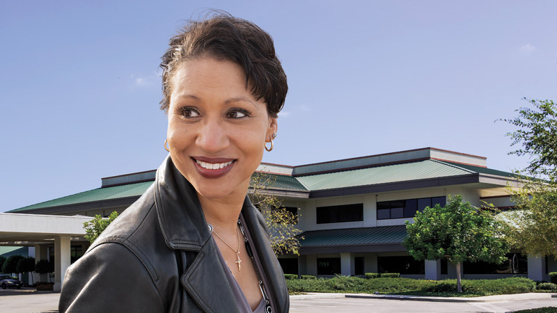 Outdoor image of a businesswoman in front of an office building